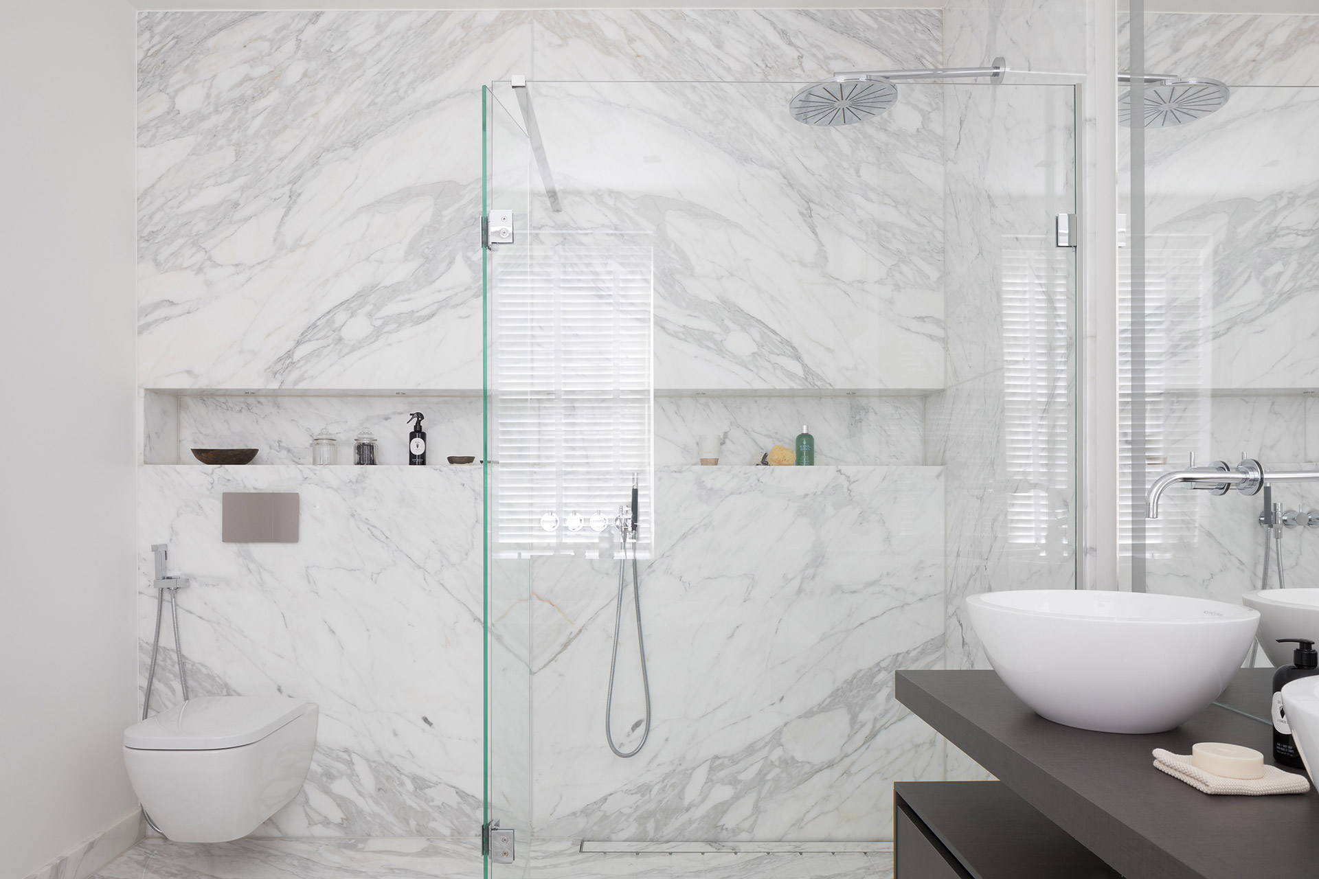 White marble carrara cladded bathroom suite